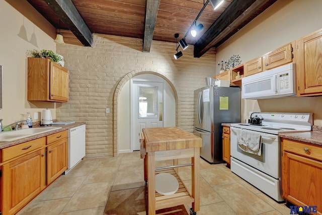 6833 Summerset Ct, Lincoln, NE 68516 - kitchen featuring white appliances, a wood ceiling with exposed beams, brick wall, arched walkways, and light tile patterned flooring