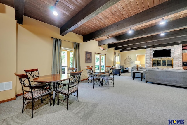 6833 Summerset Ct, Lincoln, NE 68516 - carpeted dining room with a wooden ceiling with exposed beams and a fireplace