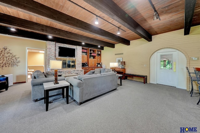 6833 Summerset Ct, Lincoln, NE 68516 - living room featuring track lighting, a wood ceiling with exposed beams, carpet, brick wall, and arched walkways