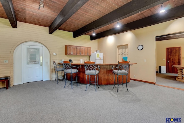 6833 Summerset Ct, Lincoln, NE 68516 - bar area with a wood ceiling with exposed beams, light colored carpet, freestanding refrigerator, and arched walkways