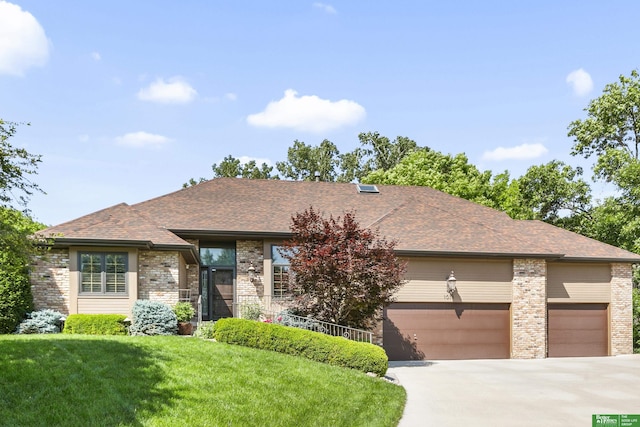 1015 N 127th Cir, Omaha, NE 68154 - view of front of property with brick siding, an attached garage, a front lawn, and driveway