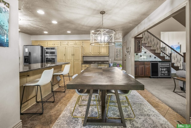 1015 N 127th Cir, Omaha, NE 68154 - dining space with beverage cooler, a chandelier, stairway, a textured ceiling, and recessed lighting