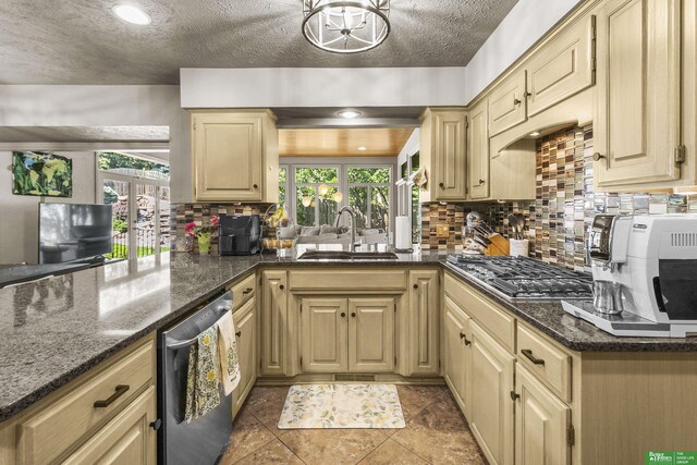 1015 N 127th Cir, Omaha, NE 68154 - kitchen with stainless steel appliances, decorative backsplash, dark stone countertops, a peninsula, and a textured ceiling