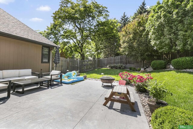 1015 N 127th Cir, Omaha, NE 68154 - fenced backyard featuring an outdoor living space with a fire pit and a patio