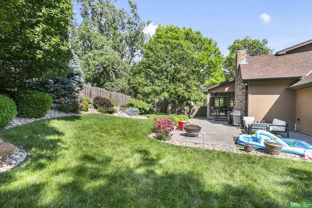 1015 N 127th Cir, Omaha, NE 68154 - view of yard featuring a patio area and an outdoor living space with a fire pit
