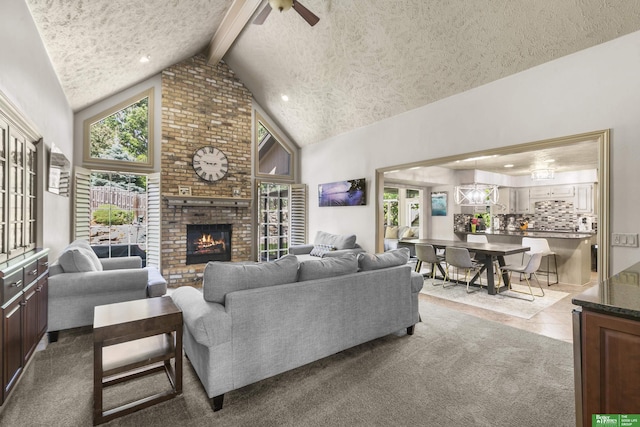 1015 N 127th Cir, Omaha, NE 68154 - carpeted living area with a textured ceiling, beam ceiling, a brick fireplace, high vaulted ceiling, and a ceiling fan