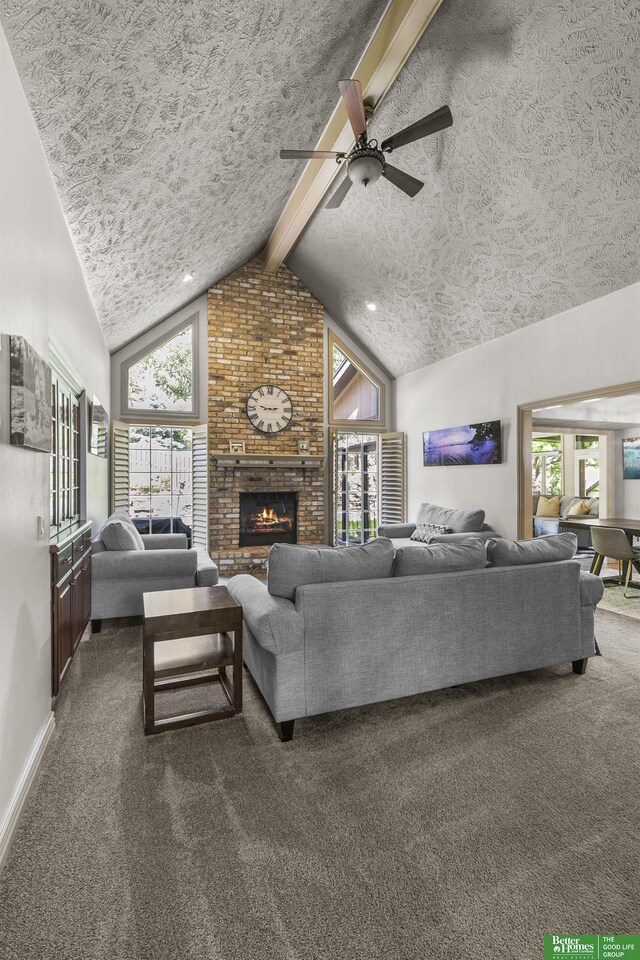 1015 N 127th Cir, Omaha, NE 68154 - living area featuring a textured ceiling, carpet flooring, a fireplace, and a ceiling fan