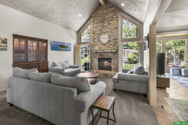 1015 N 127th Cir, Omaha, NE 68154 - living room with a fireplace, tile patterned flooring, high vaulted ceiling, a textured ceiling, and beamed ceiling