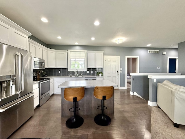 120 Snow Valley Cir, Palmyra, NE 68418 - kitchen with stainless steel appliances, decorative backsplash, recessed lighting, light countertops, and white cabinetry