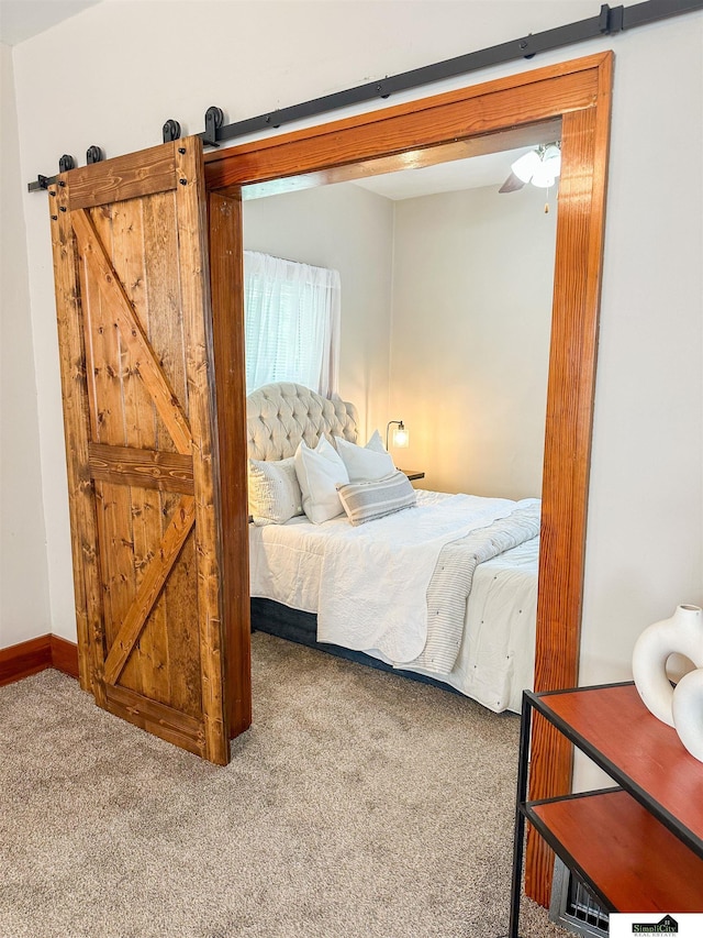 624 A St, Lincoln, NE 68502 - carpeted bedroom with a barn door and baseboards