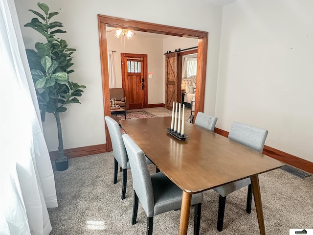 624 A St, Lincoln, NE 68502 - dining area with light carpet and a barn door