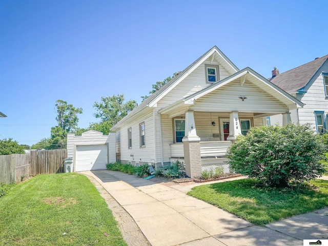 624 A St, Lincoln, NE 68502 - view of front of property with covered porch, an outbuilding, and concrete driveway