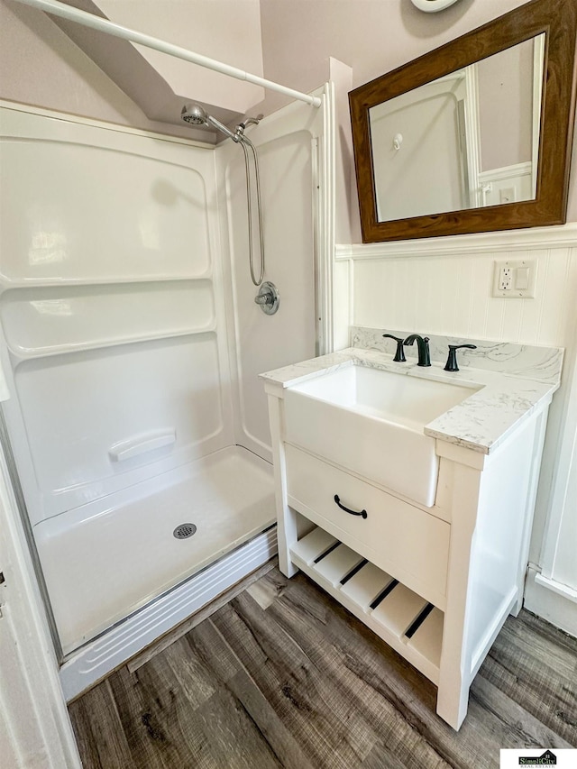 624 A St, Lincoln, NE 68502 - full bathroom with a shower stall, vanity, and wood finished floors