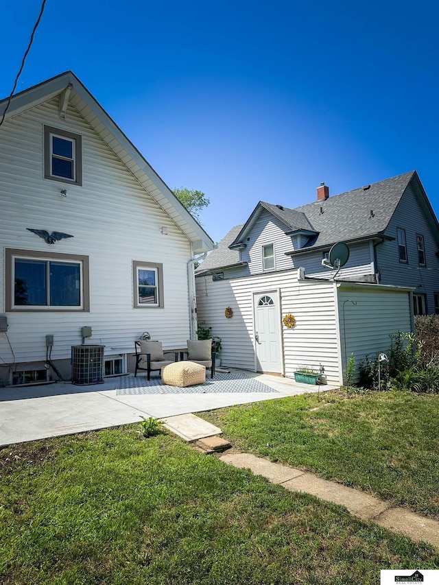 624 A St, Lincoln, NE 68502 - back of house with a patio and a lawn