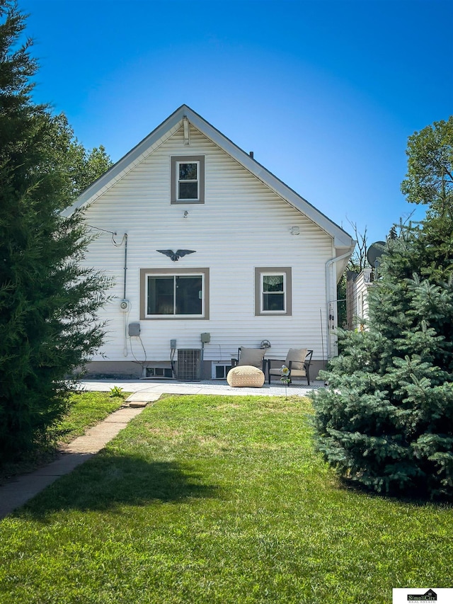 624 A St, Lincoln, NE 68502 - rear view of property featuring a yard and a patio