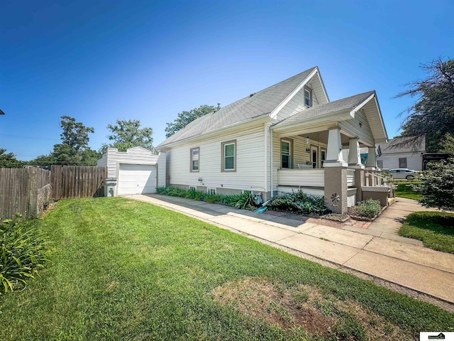 624 A St, Lincoln, NE 68502 - view of side of home with a porch, concrete driveway, and an outbuilding