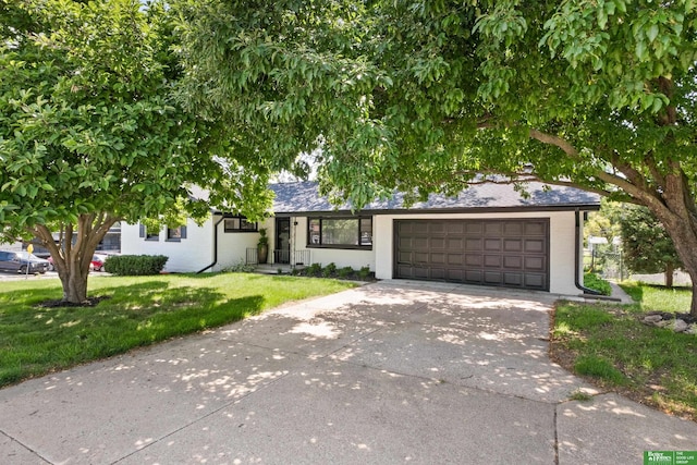 2330 S 90th St, Omaha, NE 68124 - view of front of house featuring driveway, a front lawn, and a garage