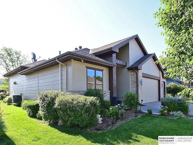 6535 N 157th St, Omaha, NE 68116 - view of home's exterior with a lawn, an attached garage, roof with shingles, and concrete driveway