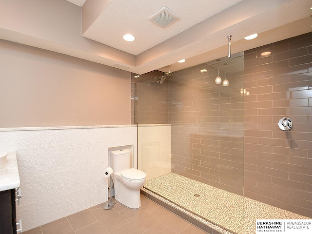 6535 N 157th St, Omaha, NE 68116 - bathroom with tiled shower, tile patterned flooring, vanity, and recessed lighting
