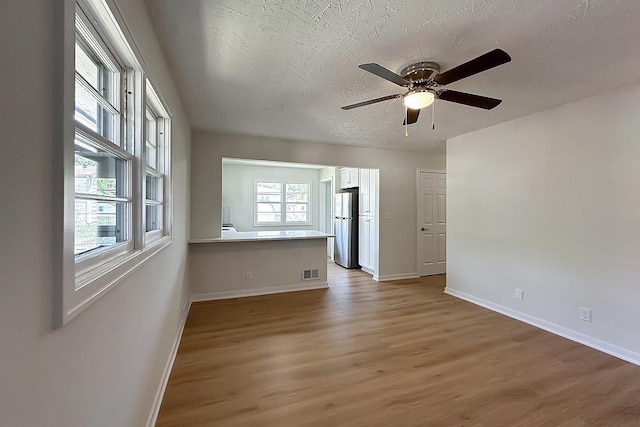 7025 S 41st St, Bellevue, NE 68147 - empty room featuring light wood-type flooring, ceiling fan, and a textured ceiling