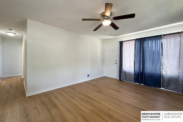 7025 S 41st St, Bellevue, NE 68147 - spare room with wood finished floors, ceiling fan, and a textured ceiling