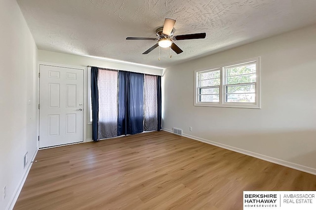 7025 S 41st St, Bellevue, NE 68147 - spare room featuring light wood-style flooring, a ceiling fan, and a textured ceiling