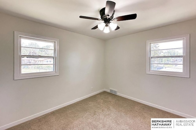 7025 S 41st St, Bellevue, NE 68147 - empty room with healthy amount of natural light, carpet, and a ceiling fan