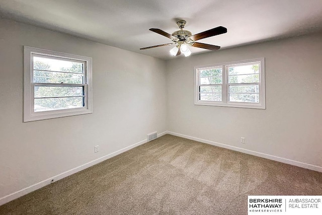 7025 S 41st St, Bellevue, NE 68147 - carpeted spare room with baseboards and a ceiling fan