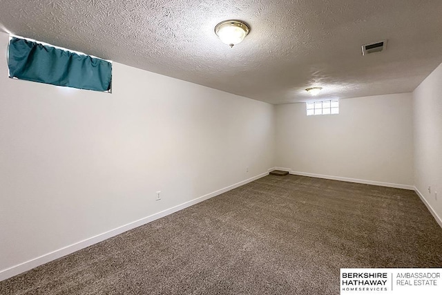 7025 S 41st St, Bellevue, NE 68147 - basement featuring dark colored carpet and a textured ceiling
