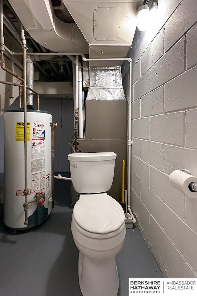 7025 S 41st St, Bellevue, NE 68147 - half bathroom with gas water heater, finished concrete flooring, and concrete block wall