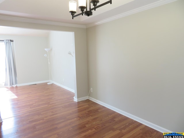 933 N 150th St, Omaha, NE 68154 - spare room with a chandelier, wood finished floors, and ornamental molding