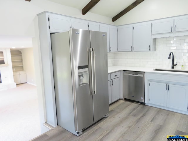 933 N 150th St, Omaha, NE 68154 - kitchen featuring appliances with stainless steel finishes, decorative backsplash, light countertops, light wood-style flooring, and white cabinets