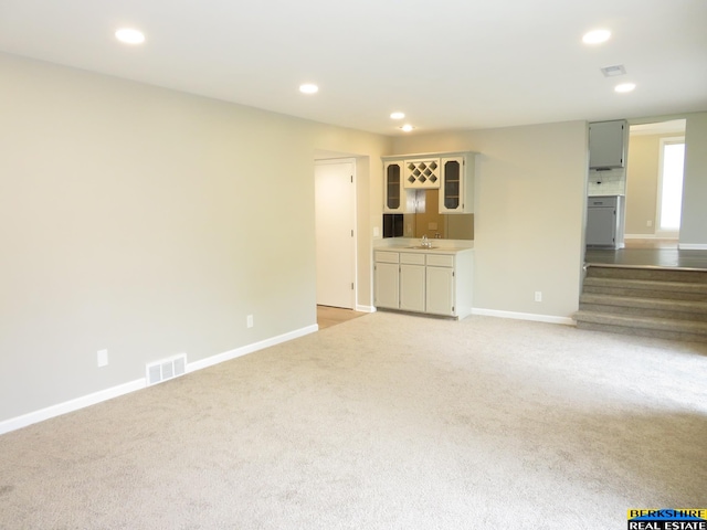 933 N 150th St, Omaha, NE 68154 - unfurnished living room featuring light colored carpet, recessed lighting, and wet bar