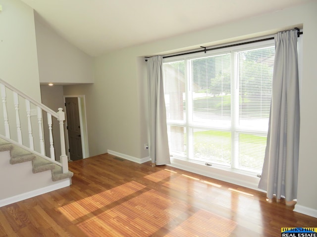 933 N 150th St, Omaha, NE 68154 - empty room featuring wood finished floors, stairs, and lofted ceiling