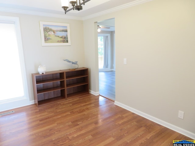 933 N 150th St, Omaha, NE 68154 - empty room featuring ornamental molding, wood finished floors, a chandelier, and ceiling fan