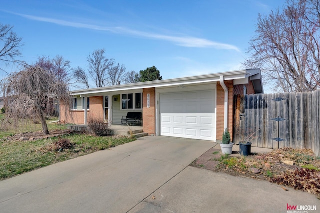 8032 E Avon Ln, Lincoln, NE 68505 - single story home featuring an attached garage, a porch, brick siding, and driveway