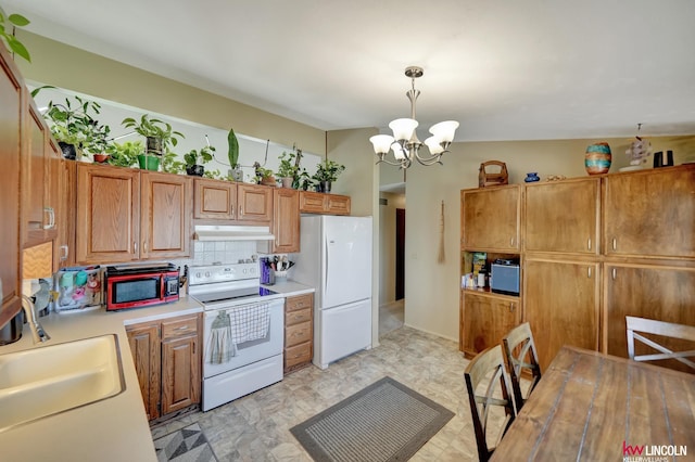 8032 E Avon Ln, Lincoln, NE 68505 - kitchen with white appliances, a chandelier, light countertops, tasteful backsplash, and under cabinet range hood