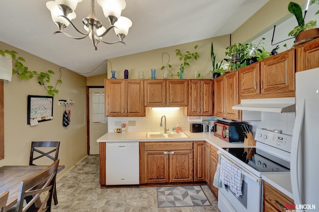 8032 E Avon Ln, Lincoln, NE 68505 - kitchen with white appliances, under cabinet range hood, lofted ceiling, light countertops, and backsplash