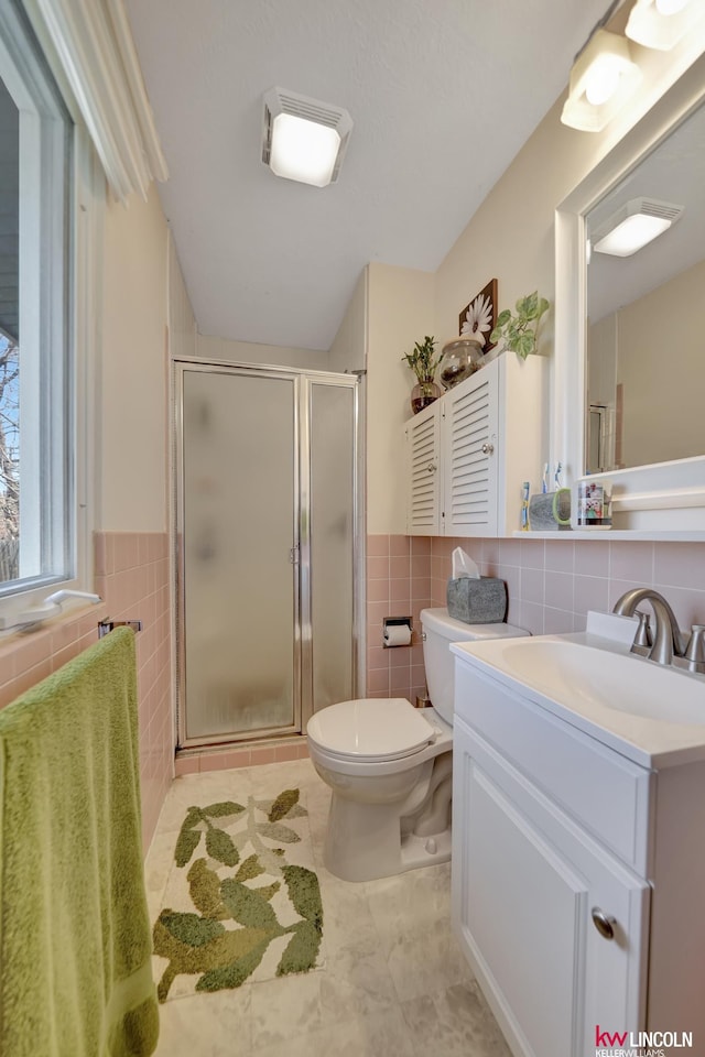 8032 E Avon Ln, Lincoln, NE 68505 - full bath featuring tile walls, vanity, a shower stall, tile patterned floors, and a wainscoted wall