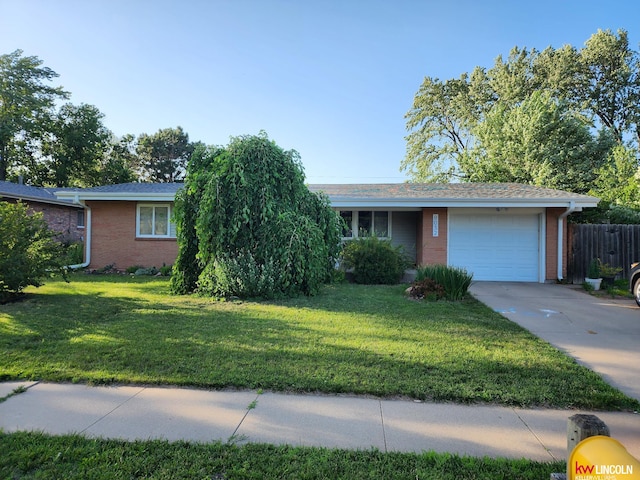 8032 E Avon Ln, Lincoln, NE 68505 - ranch-style home featuring an attached garage, brick siding, and driveway