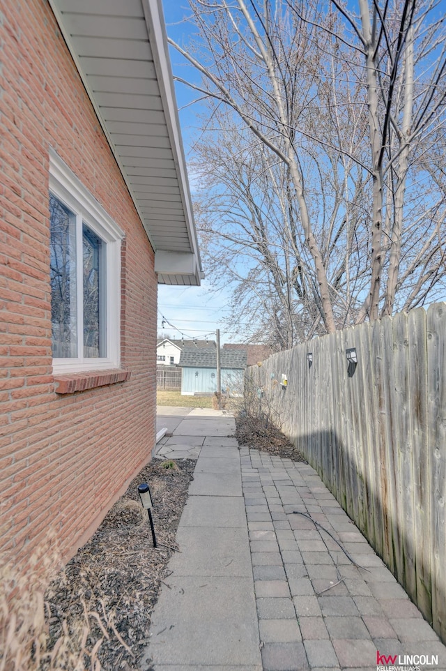 8032 E Avon Ln, Lincoln, NE 68505 - view of home's exterior with a patio area and brick siding