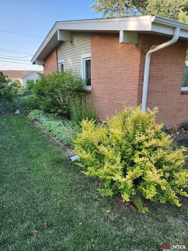 8032 E Avon Ln, Lincoln, NE 68505 - view of property exterior featuring brick siding and a yard