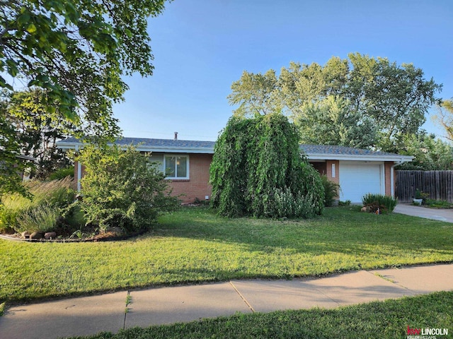 8032 E Avon Ln, Lincoln, NE 68505 - view of front of property with an attached garage, concrete driveway, and brick siding