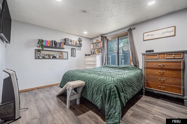 549 Washtington St, Carson, IA 51525 - bedroom with wood finished floors, a textured ceiling, recessed lighting, and access to outside