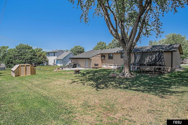 549 Washtington St, Carson, IA 51525 - view of grassy yard featuring an outdoor structure and a trampoline