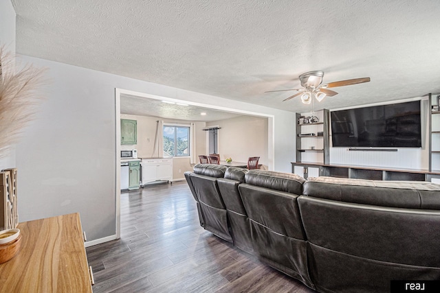 549 Washtington St, Carson, IA 51525 - living area with dark wood-style floors, ceiling fan, and a textured ceiling