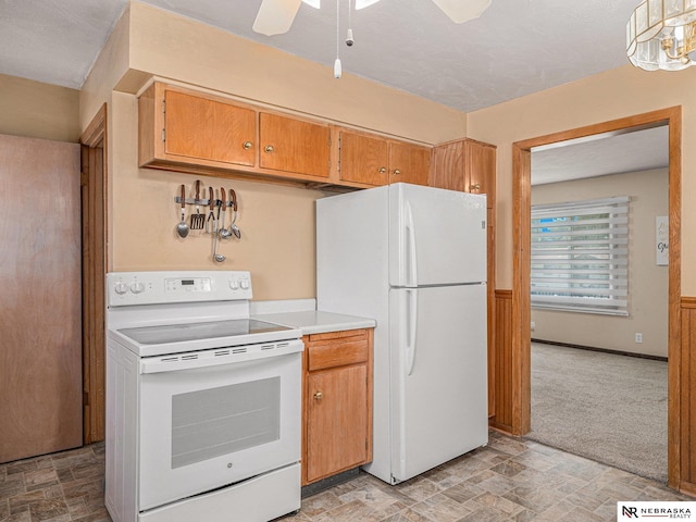 9418 Meredith Ave, Omaha, NE 68134 - kitchen with white appliances, light countertops, light colored carpet, ceiling fan, and stone finish flooring
