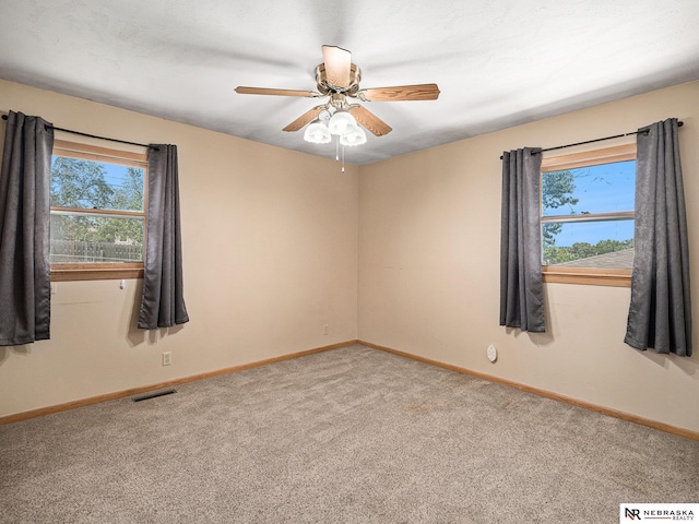 9418 Meredith Ave, Omaha, NE 68134 - spare room featuring carpet and a ceiling fan