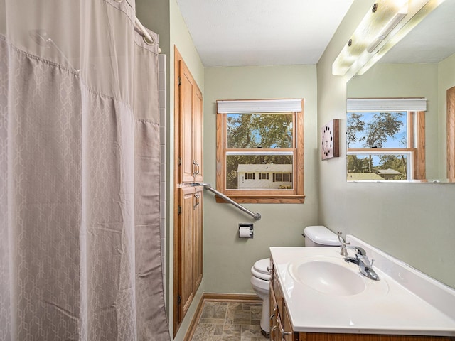 9418 Meredith Ave, Omaha, NE 68134 - bathroom with healthy amount of natural light, stone finish flooring, vanity, and curtained shower