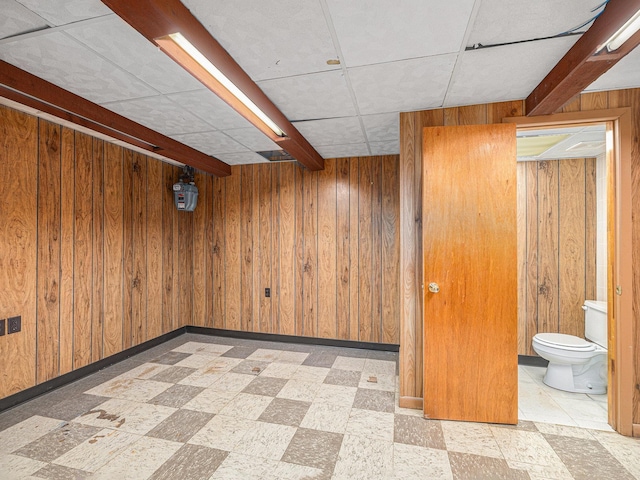 9418 Meredith Ave, Omaha, NE 68134 - finished basement with tile patterned floors, wood walls, and a paneled ceiling